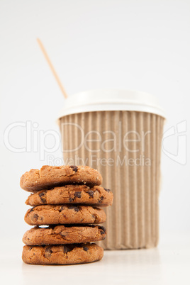 Five cookies and a cup of tea placed together