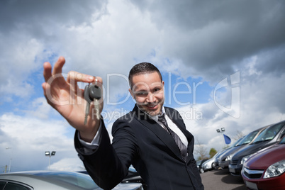 Happy seller holding car keys