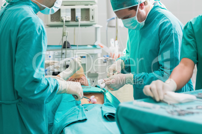 Surgeon operating a patient in an operating theater
