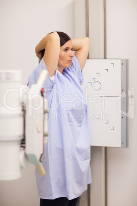 Woman placing her arms on her head while standing in front of a