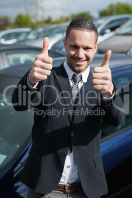 Happy man raising his thumbs