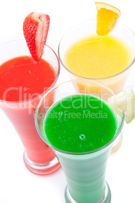 Fruits pieces placed on full glasses