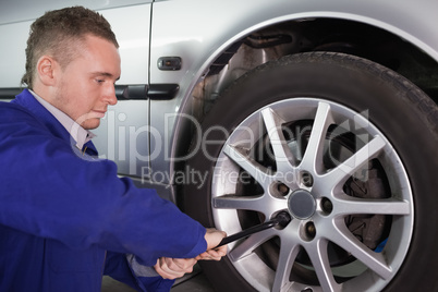 Man repairing a car wheel