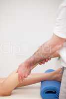 Podiatrist massaging the leg of his patient while standing