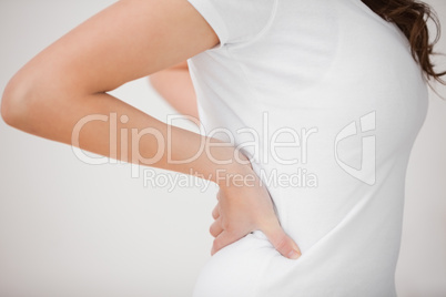 Woman putting her hands on her back