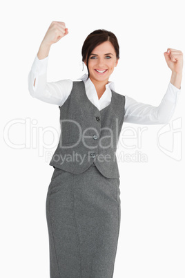 Smiling businesswoman raising her fists