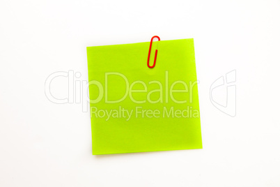 Green adhesive note with a paperclip