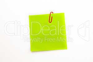 Green adhesive note with a paperclip