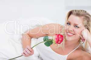 Young woman holding a beautiful rose