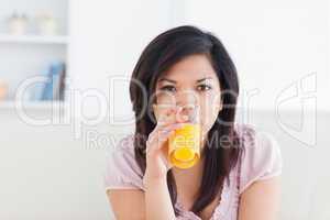 Woman drinking a glass of orange juice