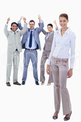 Secretary smiling and business people with their thumbs up in th