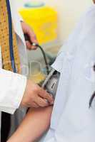 Doctor taking the blood pressure of his patient