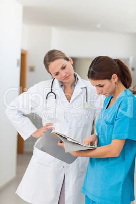 Nurse and a doctor looking in a file