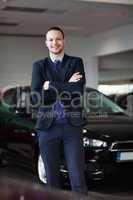 Salesman standing in front of car