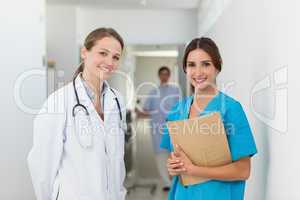 Doctor and a nurse standing side by side in a hallway