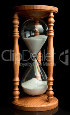 Sand flowing inside of hourglass