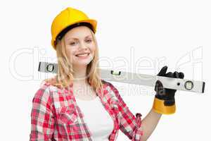 Smiling woman holding a spirit level