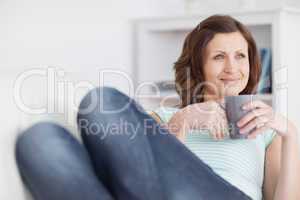 Woman looking away while holding a mug