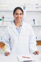 Female pharmacist smiling while looking at camera