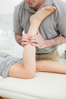 Close-up of a man massaging the leg of a woman