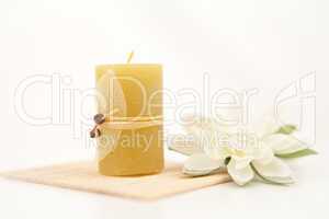 Yellow candle with a white flower