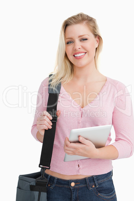 Happy blonde woman holding a shoulder bag