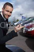 Man holding car keys with a finger