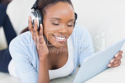 Black woman listening music with closed eyes