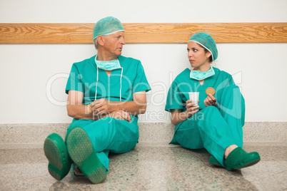 Surgeons having a break in the corridor
