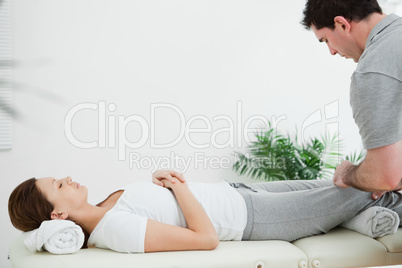 Brunette woman lying while being massaging by a man