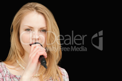 Young blonde-haired woman singing