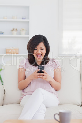 Woman surprised while looking at a phone