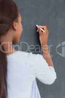 Focus on a black woman holding a chalk