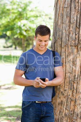 Muscled young man using a smartphone