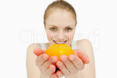 Young woman holding a tangerine