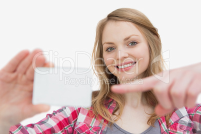 Woman holding a blank card