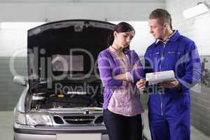 Mechanic showing the quotation to a client