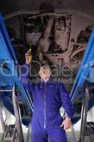 Mechanic repairing a car with an adjustable pliers