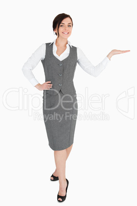 Happy well-dressed woman with her palm facing upwards