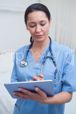 Nurse touching a tablet computer