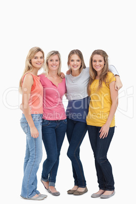 Full length of four girls standing beside each other and smiling
