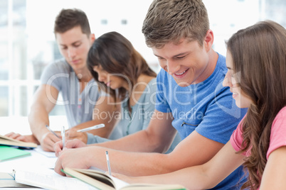 Side view of a group of people studying with each other