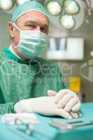 Surgeon with his hands crossed on a table