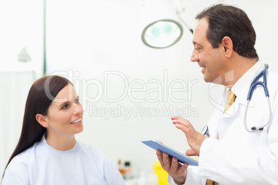 Doctor talking to a patient while holding a tablet tactile