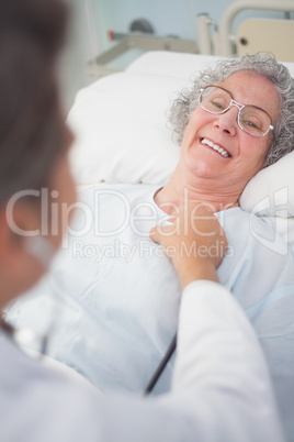 Elderly patient smiling to a doctor
