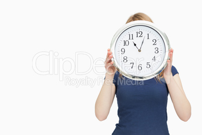 Blonde woman holding a clock