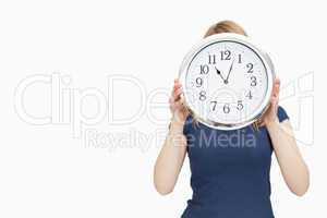 Blonde woman holding a clock