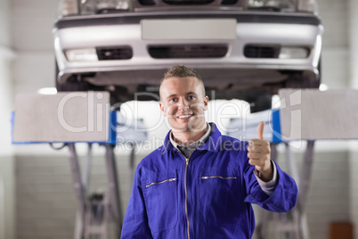 Mechanic standing with thumb up
