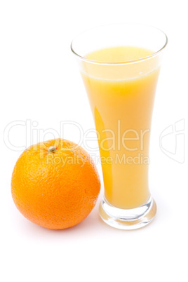 Glass full of orange juice placed near an orange