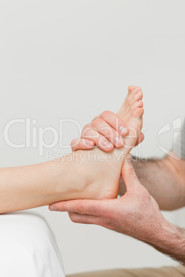 Hands of a physiotherapist massaging a foot